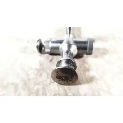 Silver-colored metal t-valve with threaded connections and stamped label for richard wolf scope sheath reuse medical use