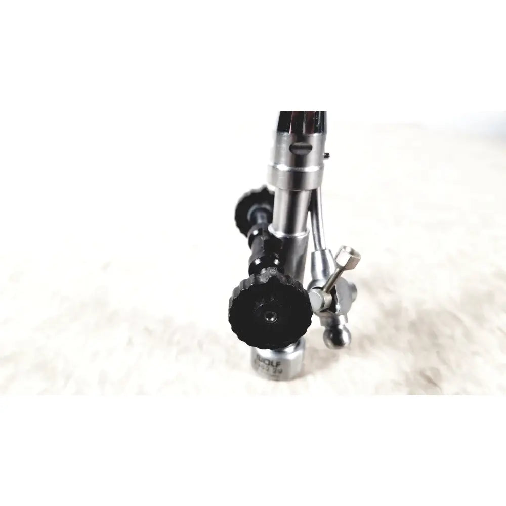 Silver and black gas torch with textured grip knobs and engraved richard wolf branding for urology deflecting bridge use
