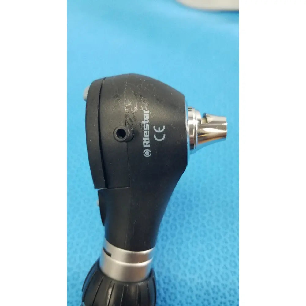 Black riester otoscope with metallic silver tip and textured grip on ri-charger l charging base for reuse medical use