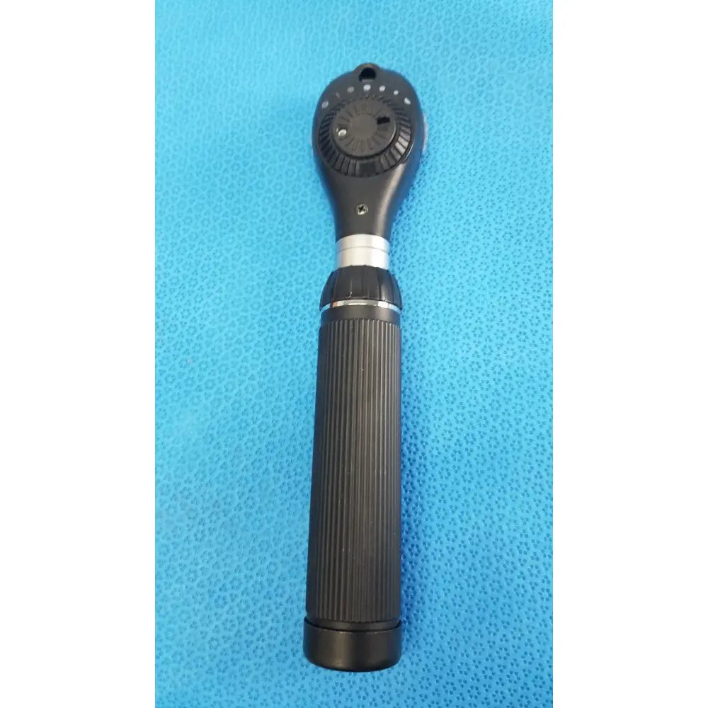 Black handheld ophthalmoscope with textured grip and adjustable dial in riester ri-charger l charging base