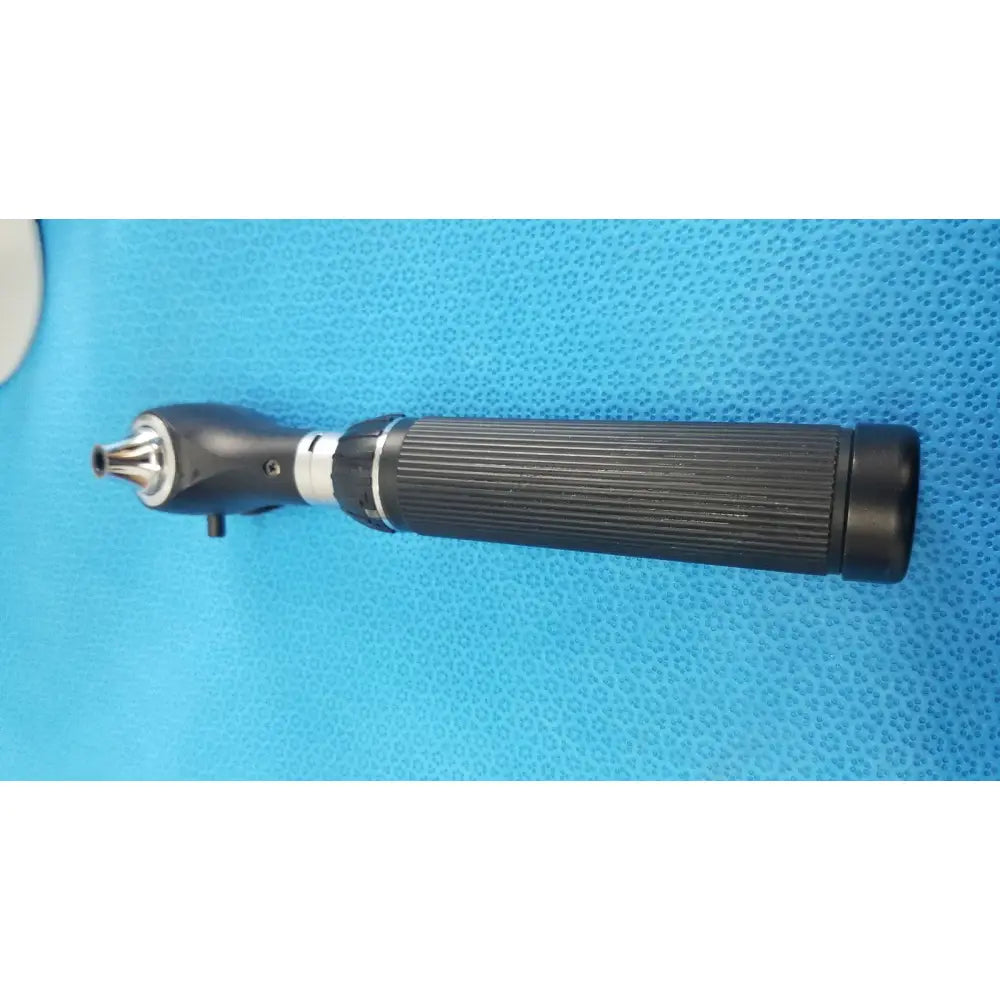 Black ribbed-handled otoscope with metallic tip and silver band in riester ri-charger l charging base for reuse medical use
