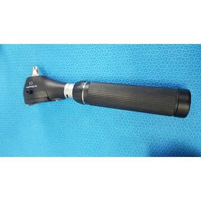Black ergonomic otoscope with textured grip and silver metallic tip in riester ri-charger l charging base product image