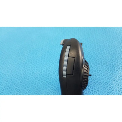 Black plastic handheld fan with gray textured grip and vented side panel for riester ri-charger l charging base
