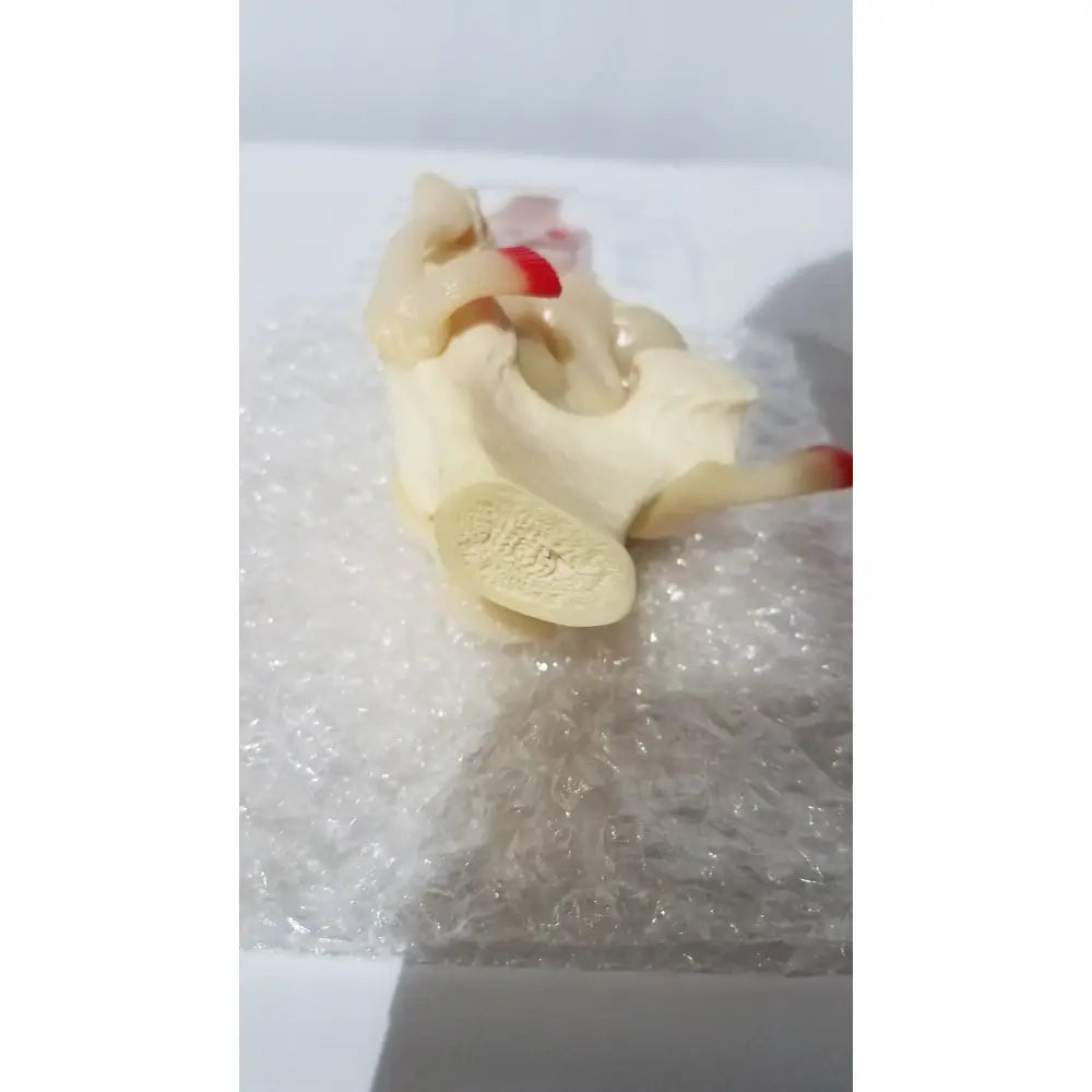 Right knee anatomical model in pale yellow with detailed red-tipped appendages for medical education use