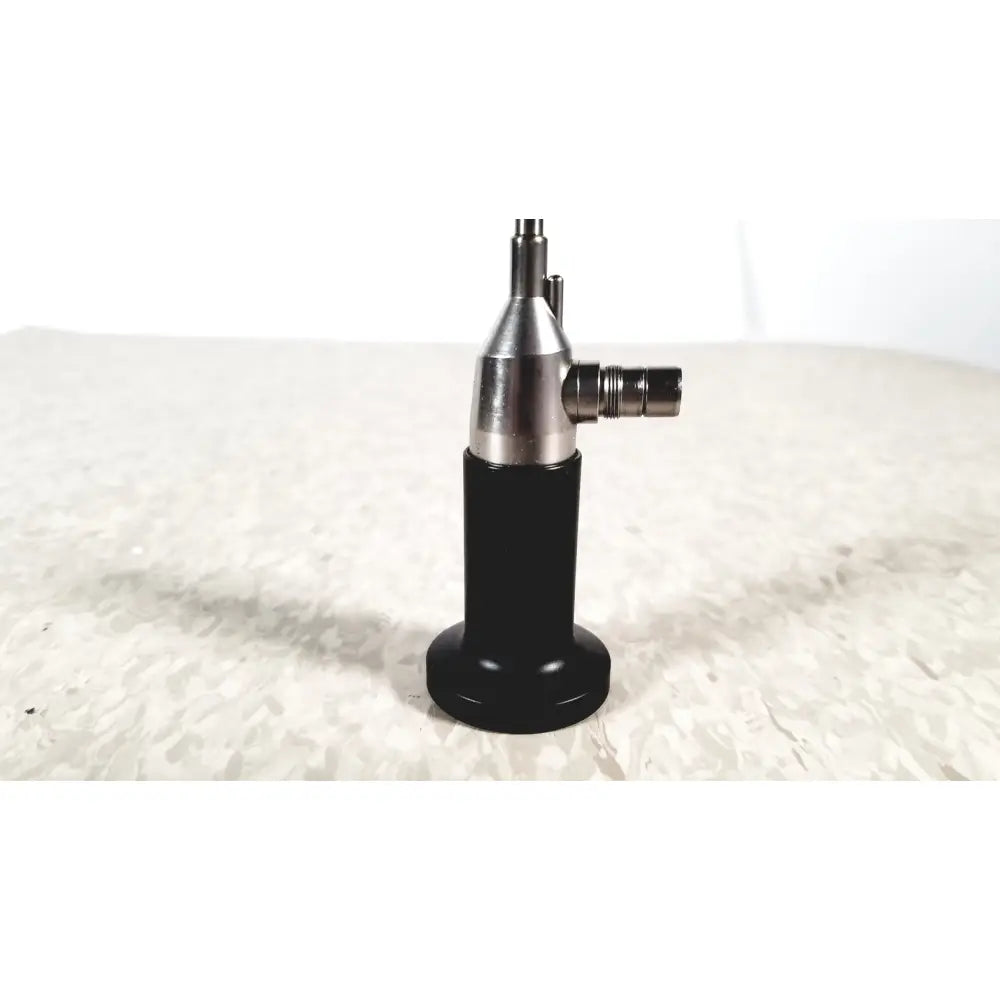 Black and silver rigid cystoscope 94509 with a cylindrical body and metallic joints designed for reuse medical procedures