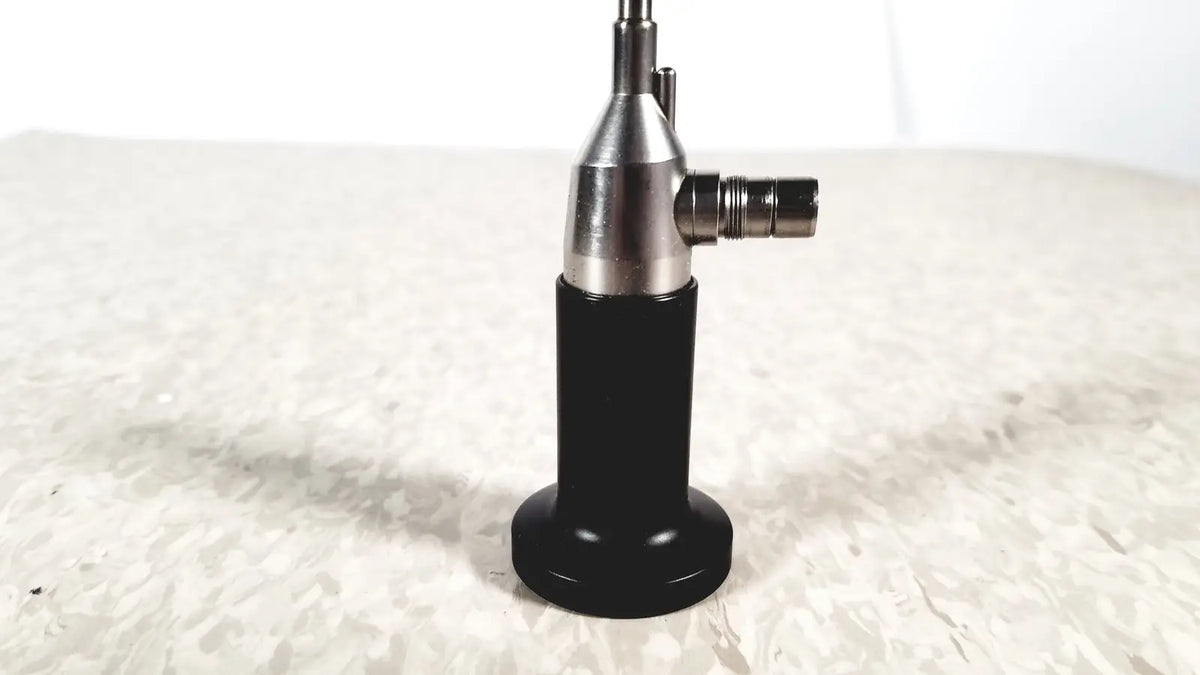 Black and silver rigid cystoscope 94509 with a cylindrical body and metallic joints designed for reuse medical procedures