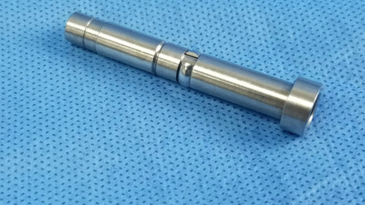 Silver metallic cylindrical rigid endoscope optical fiber interface adapter connector with machined grooves and threaded ends
