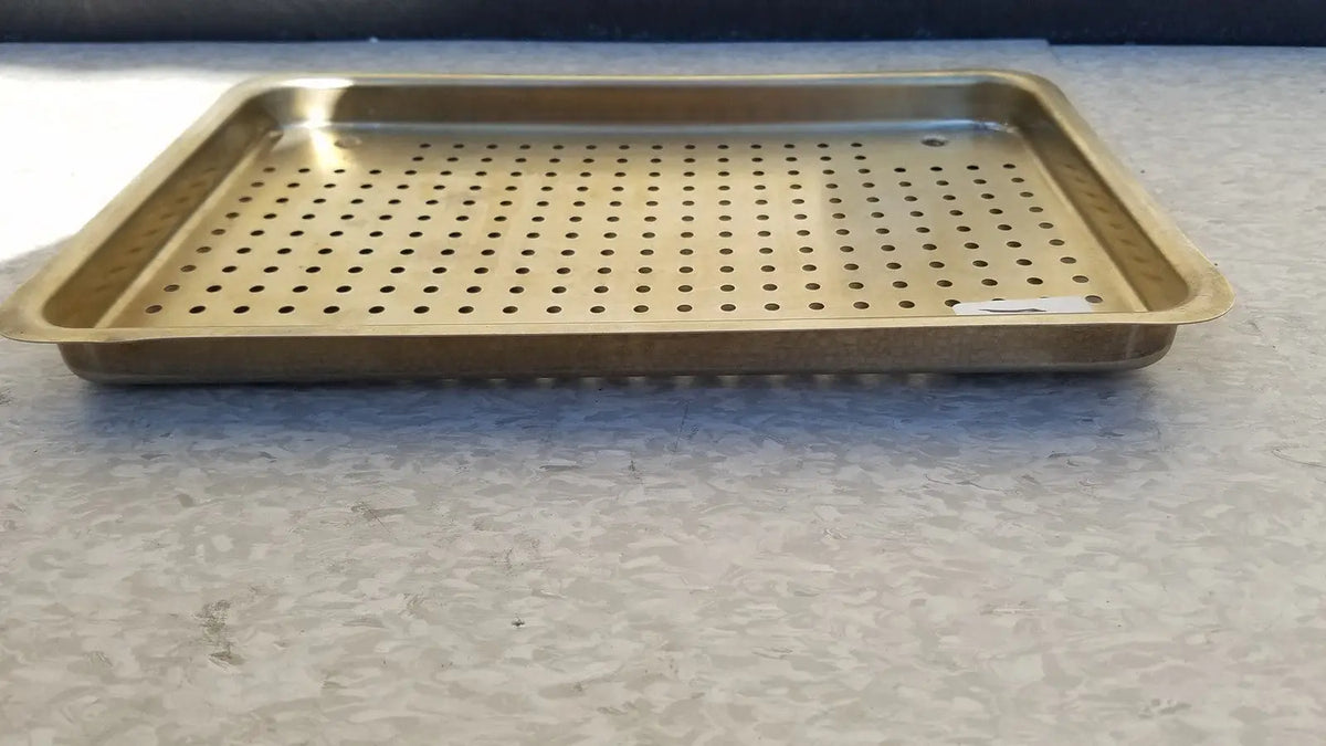 Gold-colored rectangular metal ritter autoclave sterilizer tray with evenly spaced perforations for sterilization use