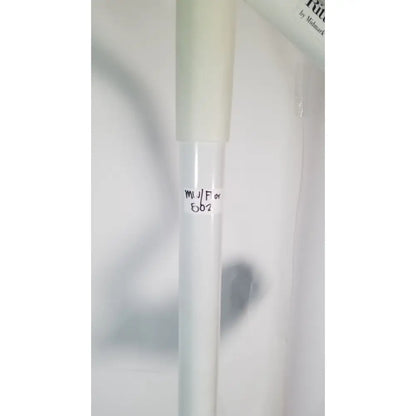 A translucent white cylindrical tube with a frosted cap and handwritten labeling for ritter midmark portable surgery procedure light