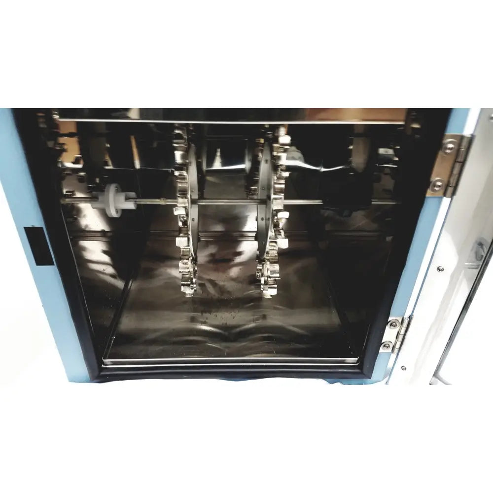 Industrial-grade stainless steel gear assembly inside blue and white chamber of robbins scientific hybridization incubator model 400
