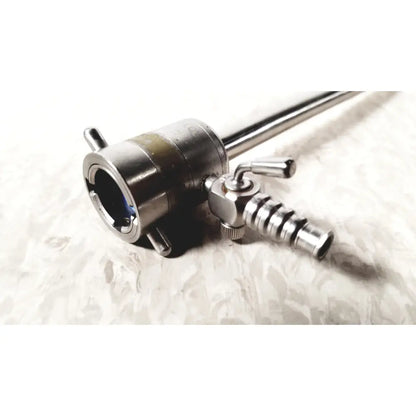 Stainless steel rotating single stopcock cannula with cylindrical body, threaded connectors, and adjustment knobs