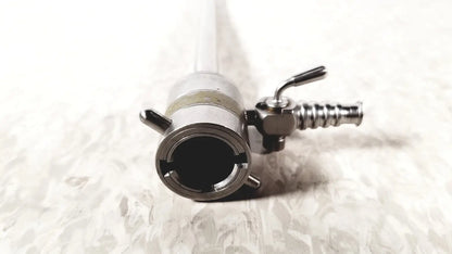 Silver metallic rotating single stopcock cannula with cylindrical body, threaded connections, and small lever mechanism