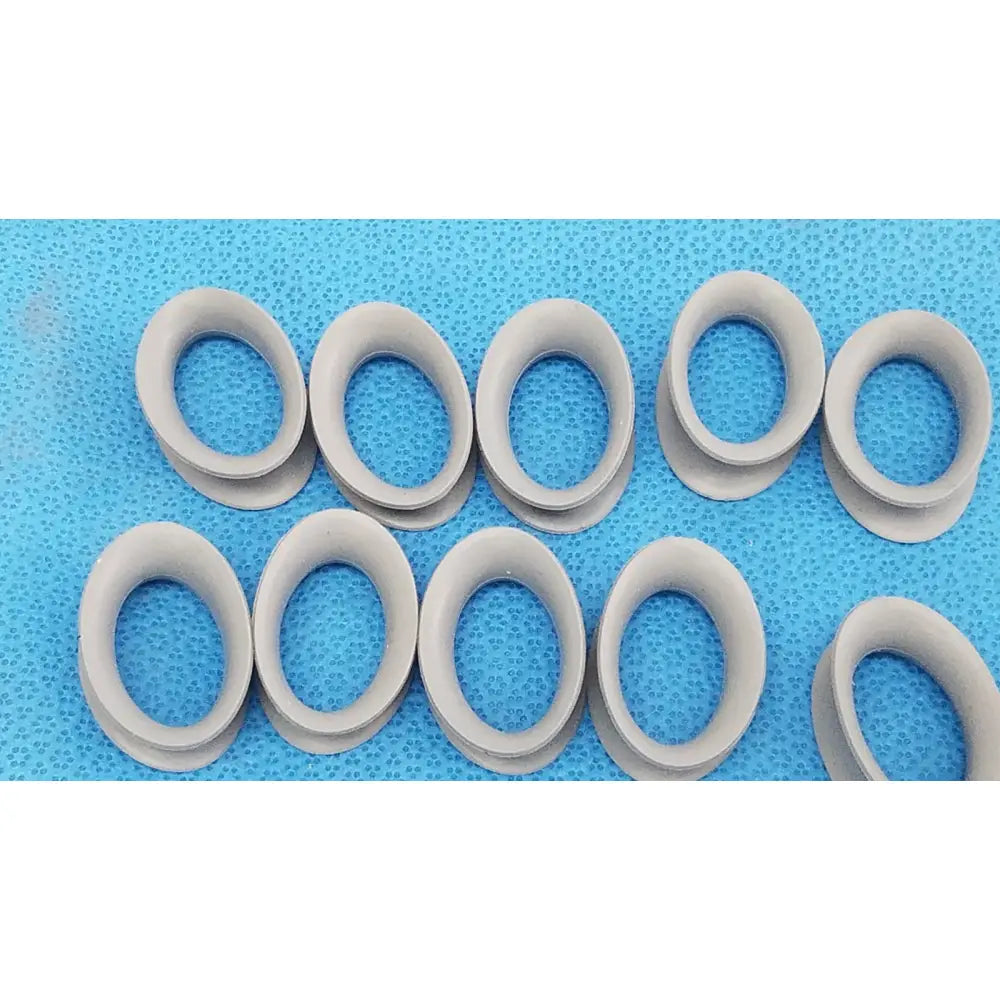 Gray silicone rubber ring gaskets arranged on a blue surface for reuse medical applications front and back view