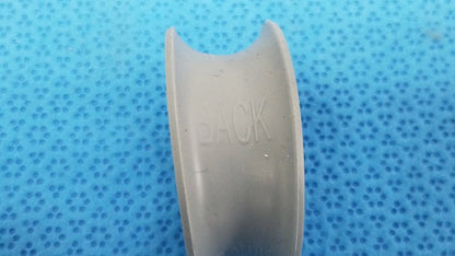 Gray plastic dental retainer showing back side with embossed back text in rubber ring front/back for reuse medical purposes