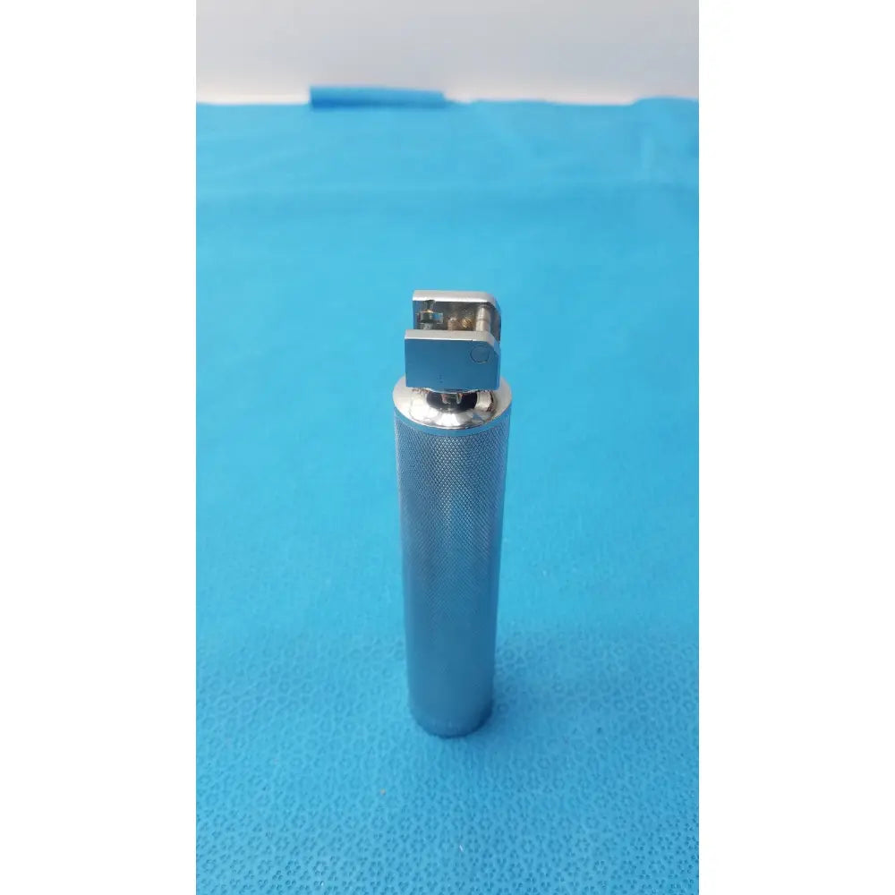 Silver metallic rusch standard laryngoscope with textured cylindrical standard laryngoscope handle short stubby design