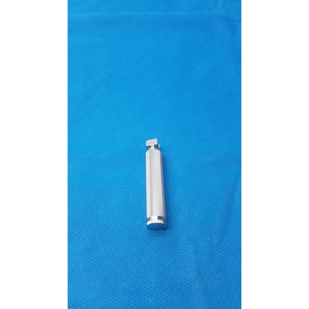 Silver metallic rusch standard laryngoscope handle short with textured cylindrical body and threaded ends for secure grip