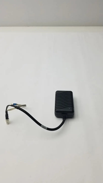 Black plastic safety mark 2403srm 30 charger with textured ribbed surface and coiled cable ending in connector