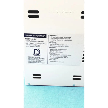 White plastic safevac smoke evacuator with black ventilation slits and technical specifications label visible on the back side