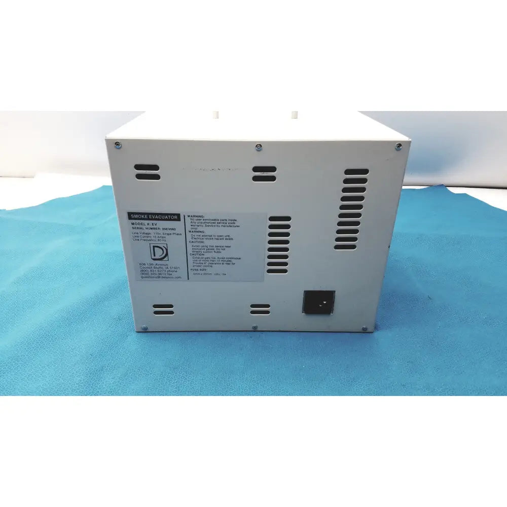 White rectangular safevac smoke evacuator ev 09ev063 back side with ventilation slots and power input port
