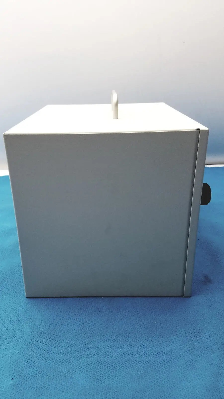 Gray metal safevac smoke evacuator with white top and black handle designed for reuse medical applications