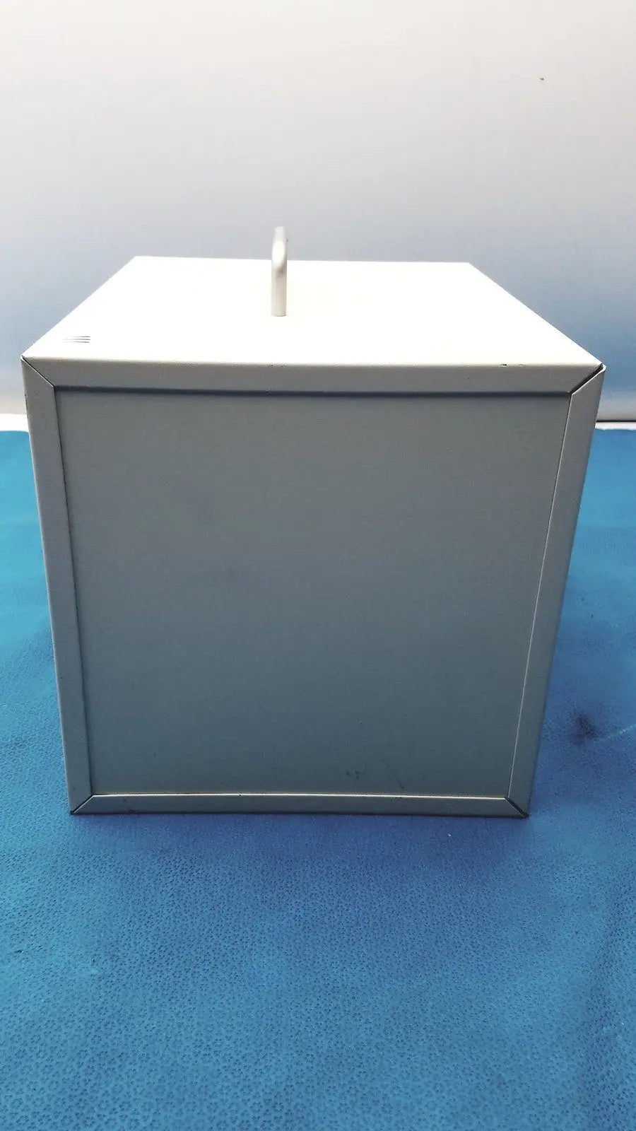 Gray metal ballot box with white slot on top for safEvac smoke evacuator reuse medical applications