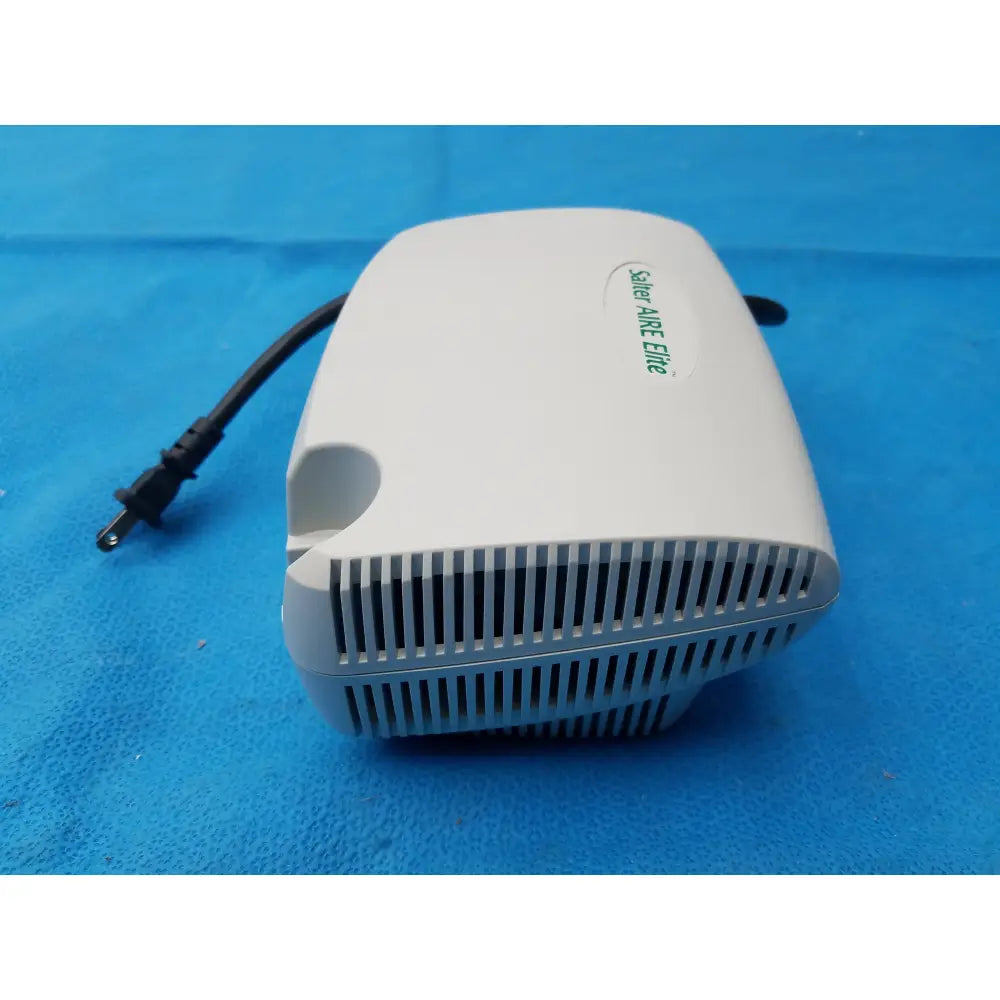 White plastic salter labs aire elite compressor nebulizer with green branding and a black power cord