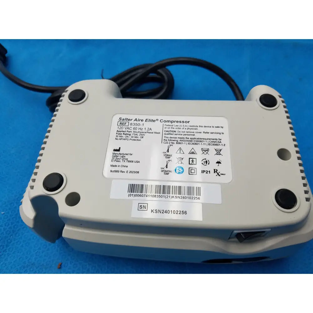 Gray plastic salter labs aire elite compressor nebulizer with black feet and label showing model number and certifications