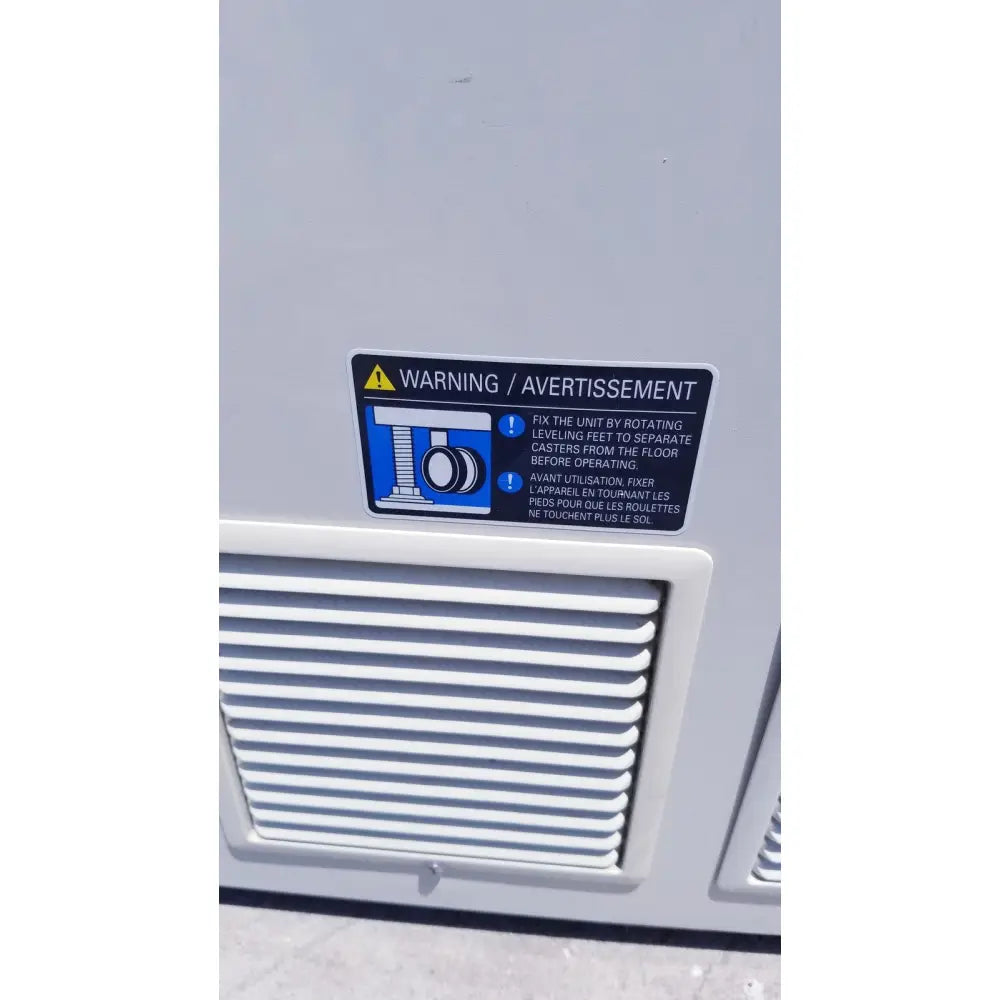Gray industrial sanyo vip series ultra low temperature freezer back with black warning label and bilingual leveling feet instructions