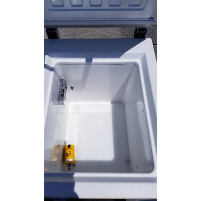White plastic chest freezer from sanyo vip series ultra low with yellow and black labeled component inside