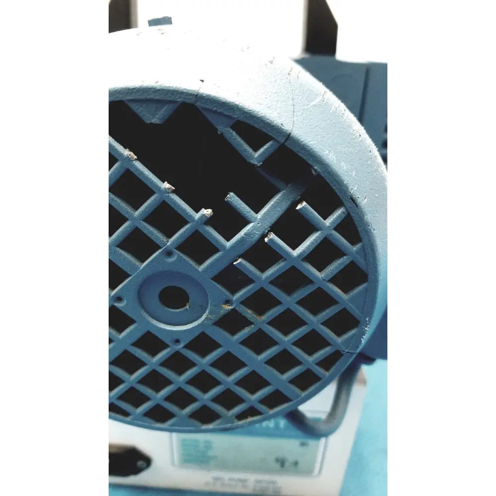 Blue industrial fan with diamond grille and wear on painted surface of savant gel pump gp100 gel pump unit