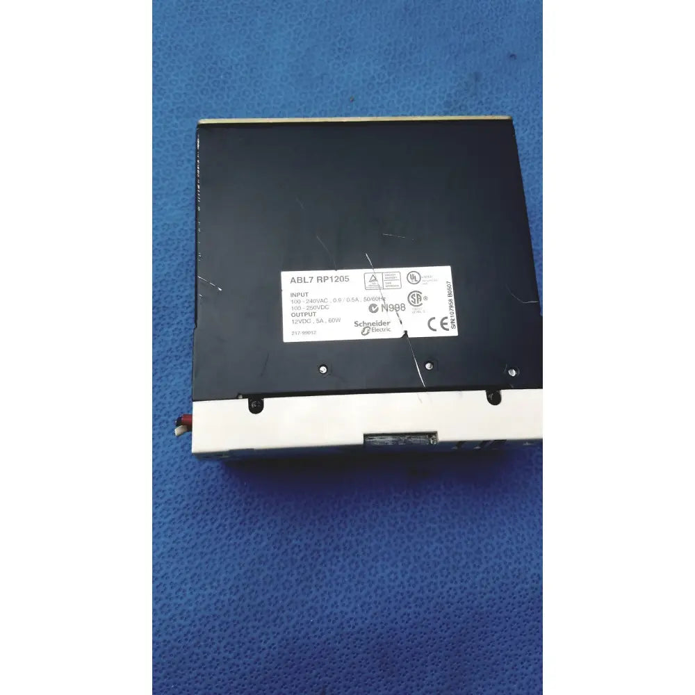 Black rectangular schneider electric abl7 rp1205 switch mode power supply with white label and technical specifications