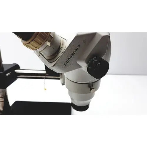 Silver metallic ssz stereo zoom binocular microscope with black adjustment knobs and engraved sciencecope branding