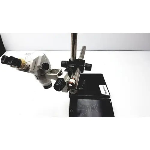 Silver and black ssz stereo zoom binocular microscope with adjustable focus knobs on a sturdy metal stand