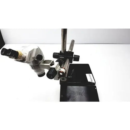 Silver and black ssz stereo zoom binocular microscope with adjustable focus knobs on a sturdy metal stand
