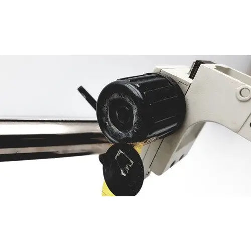 Black textured knob on white plastic handle of Scienscope ssz stereo zoom binocular microscope for precise adjustments