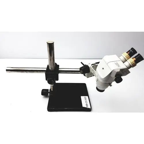 White and black ssz stereo zoom binocular microscope with adjustable arms mounted on a sturdy metal stand