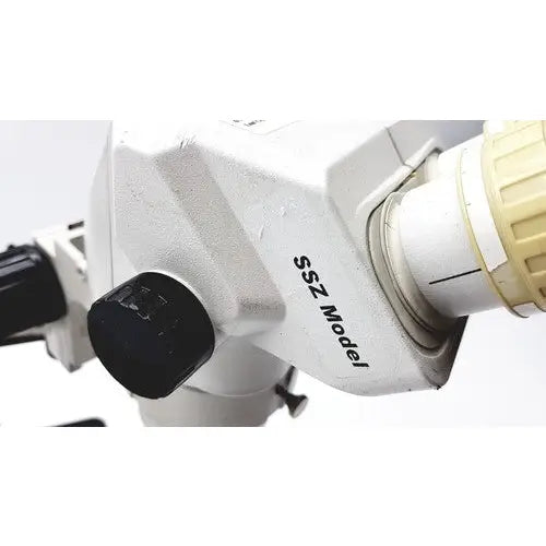 White metal ssz stereo zoom binocular microscope with black adjustment knobs and beige eyepiece for precise observation