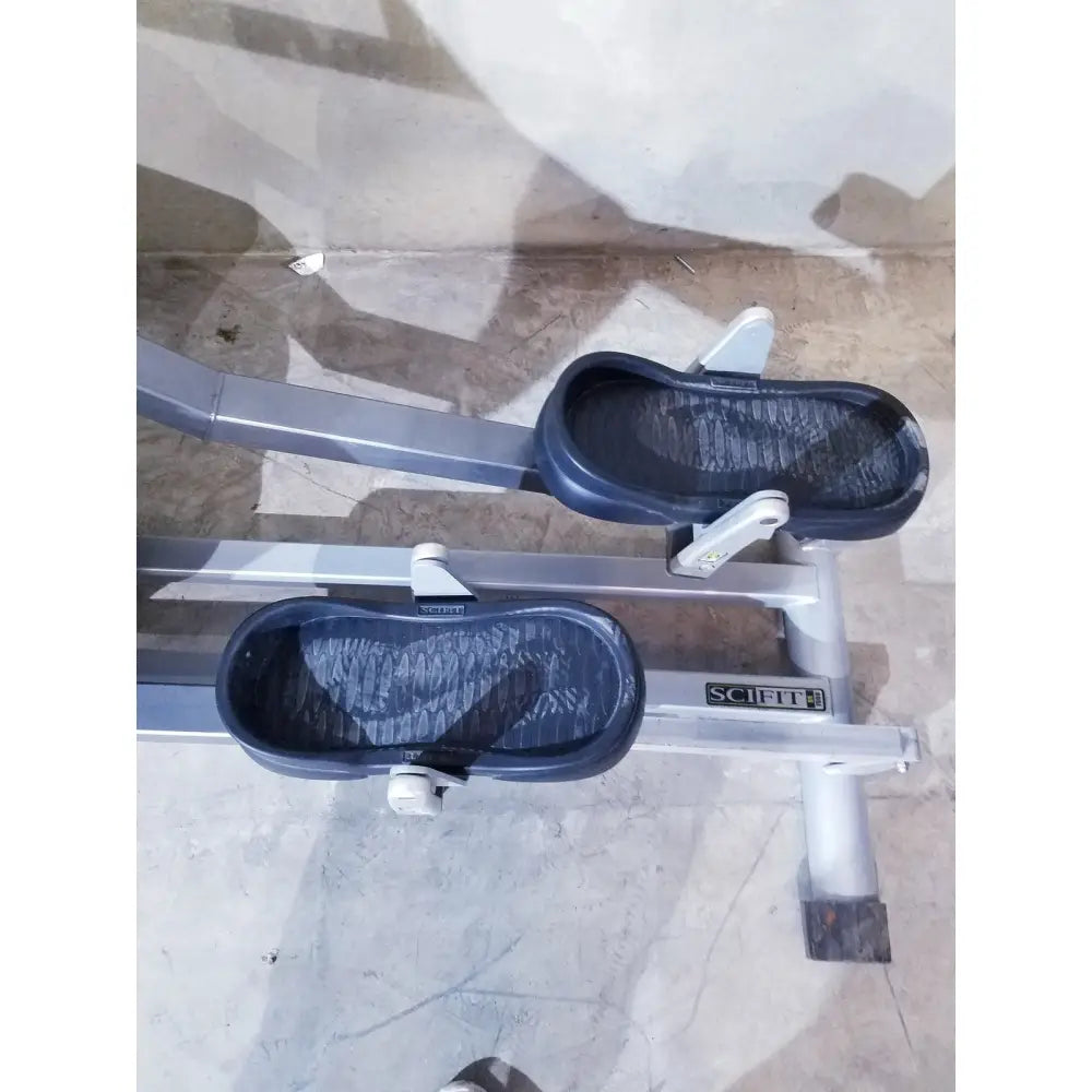 Gray and black scifit sx7000 elliptical commercial lower body trainer with textured footpads and self-powered design