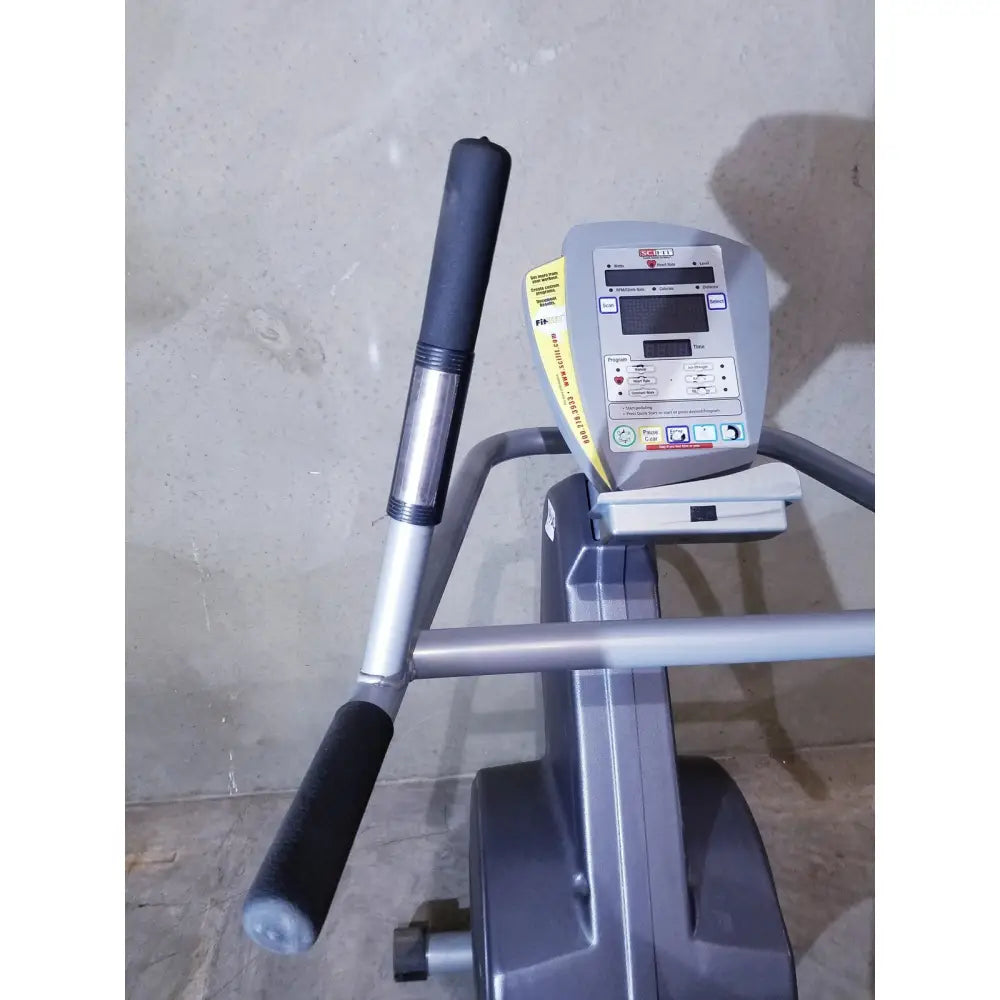 Gray scifit sx7000 elliptical commercial lower body trainer with black padded handles and digital display panel