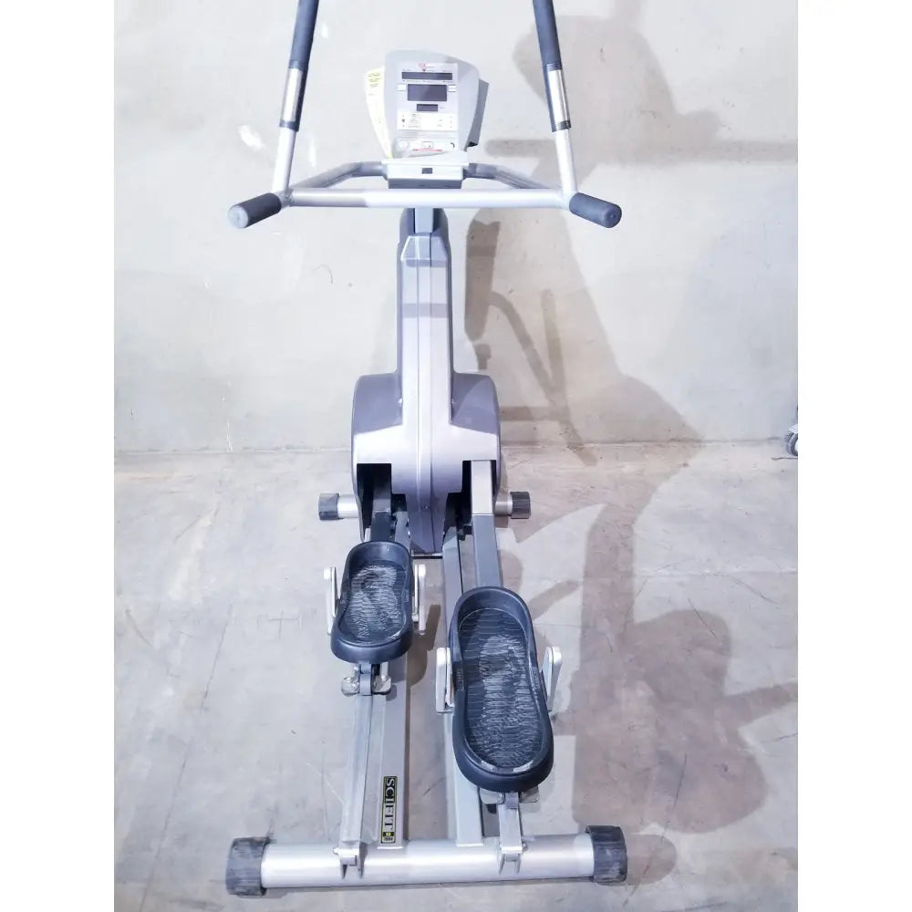 Silver and gray scifit sx7000 elliptical commercial lower body trainer with black foot pedals and handlebars self powered