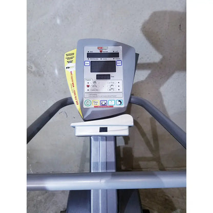 Gray and white scifit sx7000 elliptical commercial console with digital display control buttons and yellow informational sticker