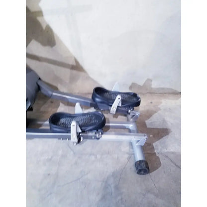 Silver-framed scifit sx7000 elliptical commercial lower body trainer with black foot pedals and textured rubber grips