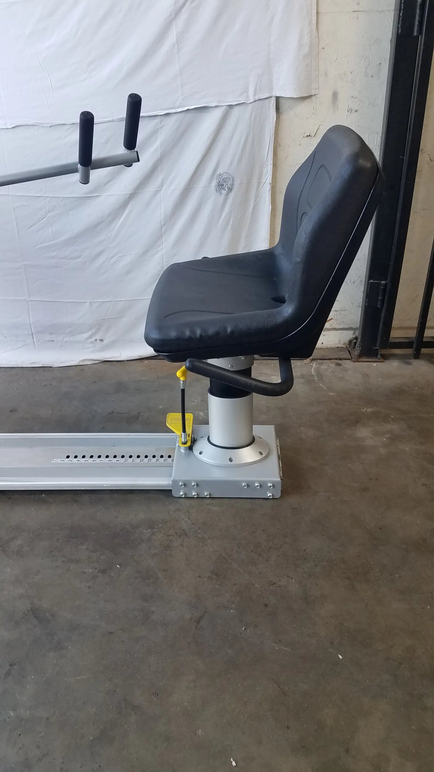 Black upholstered seat with silver metal base and adjustable height on scifit systems rst7000 recumbent stepper