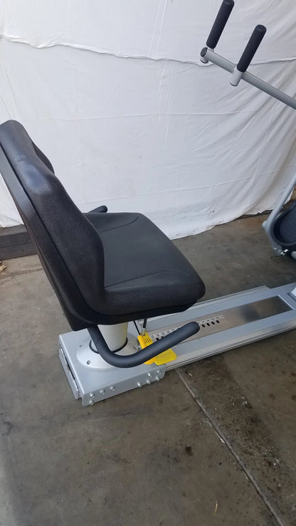 Black padded seat with silver metal frame and black handlebars of scifit systems rst7000 recumbent stepper