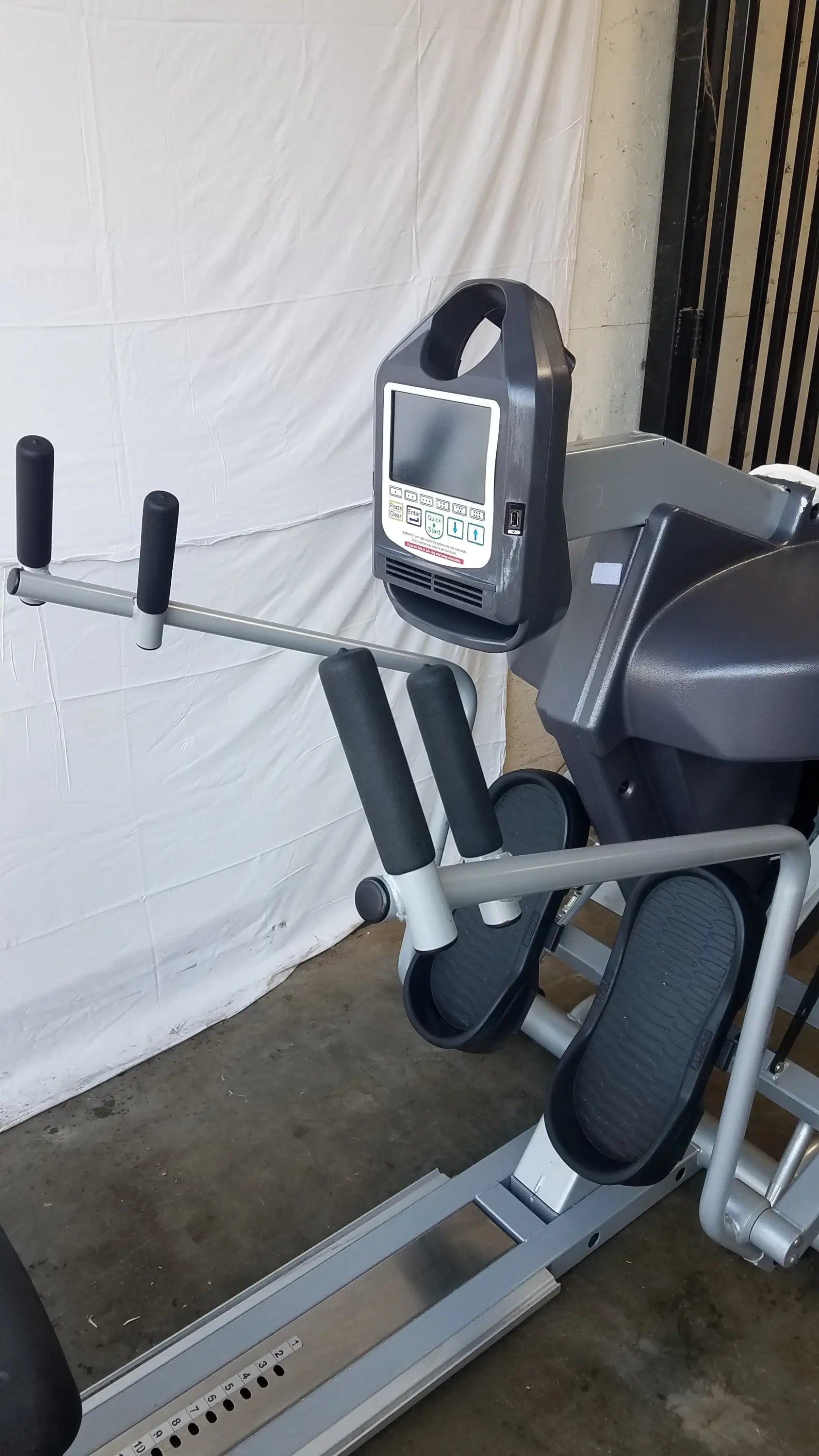 Gray and black scifit systems rst7000 recumbent stepper with digital display screen mounted on handle for fitness use