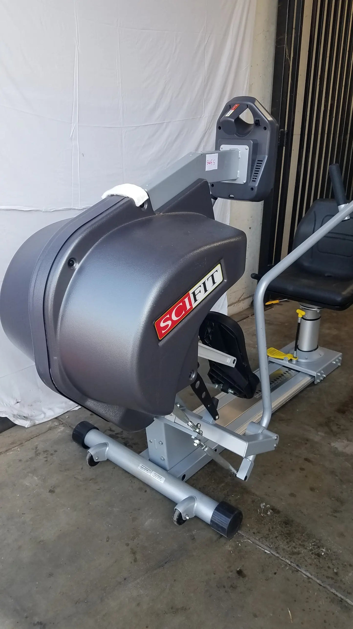 Gray and silver scifit systems rst7000 recumbent stepper leg press machine with black padded seat and handlebars