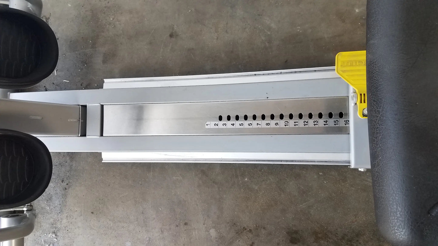 Silver metallic track of scifit systems rst7000 recumbent stepper with black foot pedals and yellow adjustment lever