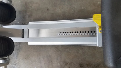 Silver metallic track of scifit systems rst7000 recumbent stepper with black foot pedals and yellow adjustment lever