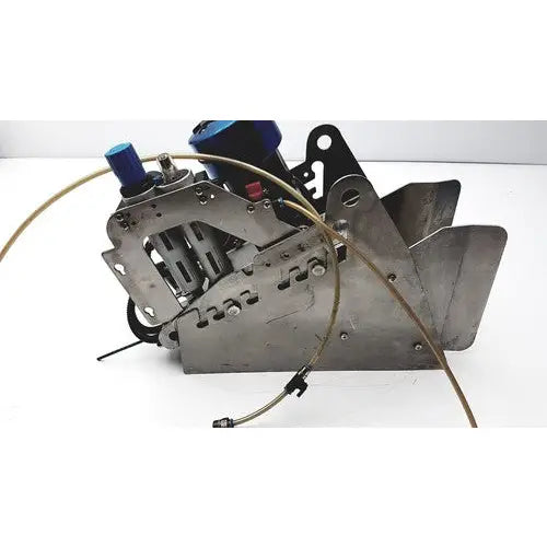 Industrial-grade pneumatic fish stunner with blue hydraulic fittings and exposed metal components by Seafood Innovations