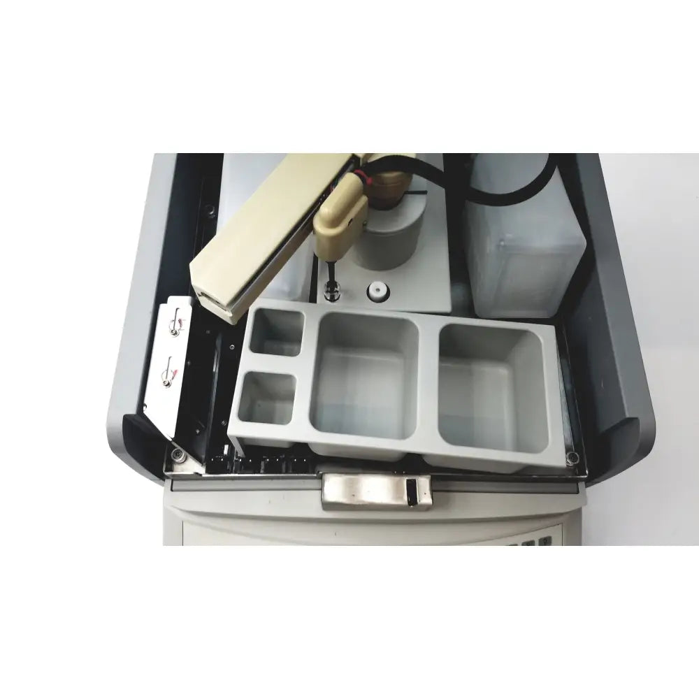Beige robotic arm with articulated joints and cylindrical nozzle mounted on gray machine in sebia hydraplus 2 autosampler for reuse medical chromatography systems